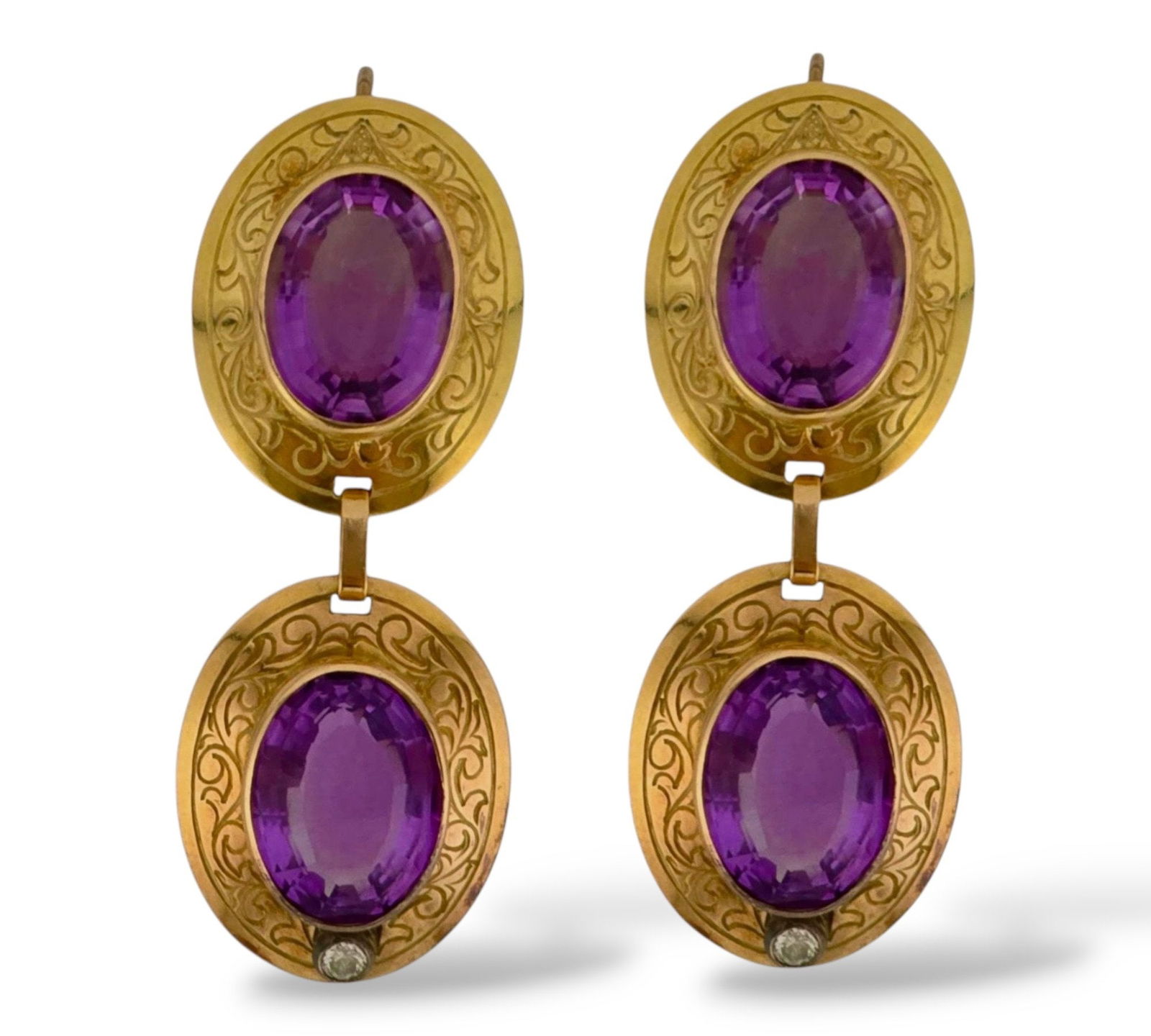 14 kt. Yellow gold, Antique Diamond and Regal Amethyst Oval Earrings in 14K Gold Amethyst: Antique Diamond and Regal Amethyst Oval Earrings in 14K GoldThese striking earrings are crafted in 14K yellow gold and showcase four large oval-cut purple gemstones that exude rich, regal color. Accen