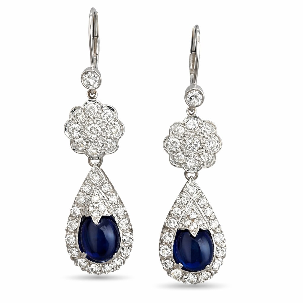 14 kt. Exclusive 14K White Gold 7.00ct Sapphire and 2.36ct Diamond Drop Earrings, White gold -: Exclusive 14K White Gold 7.00ct Sapphire and 2.36ct Diamond Drop EarringsThese elegant drop earrings are crafted in 14K white gold and feature oval cabochon sapphires at the center of each earring, fr