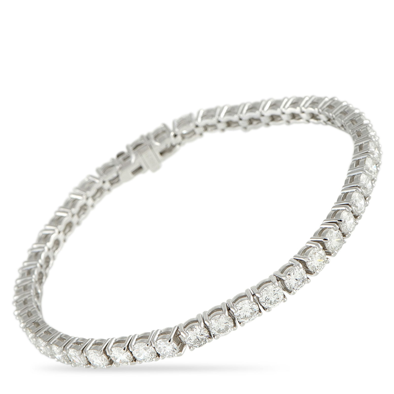 14K White Gold 9.80ct Diamond Tennis Bracelet: A white gold bracelet gleaming with 9.80 carats of carefully selected diamonds. This Exclusive piece showcases a clean, continuous line of glitter that creates a fluid, elegant movement around the wri