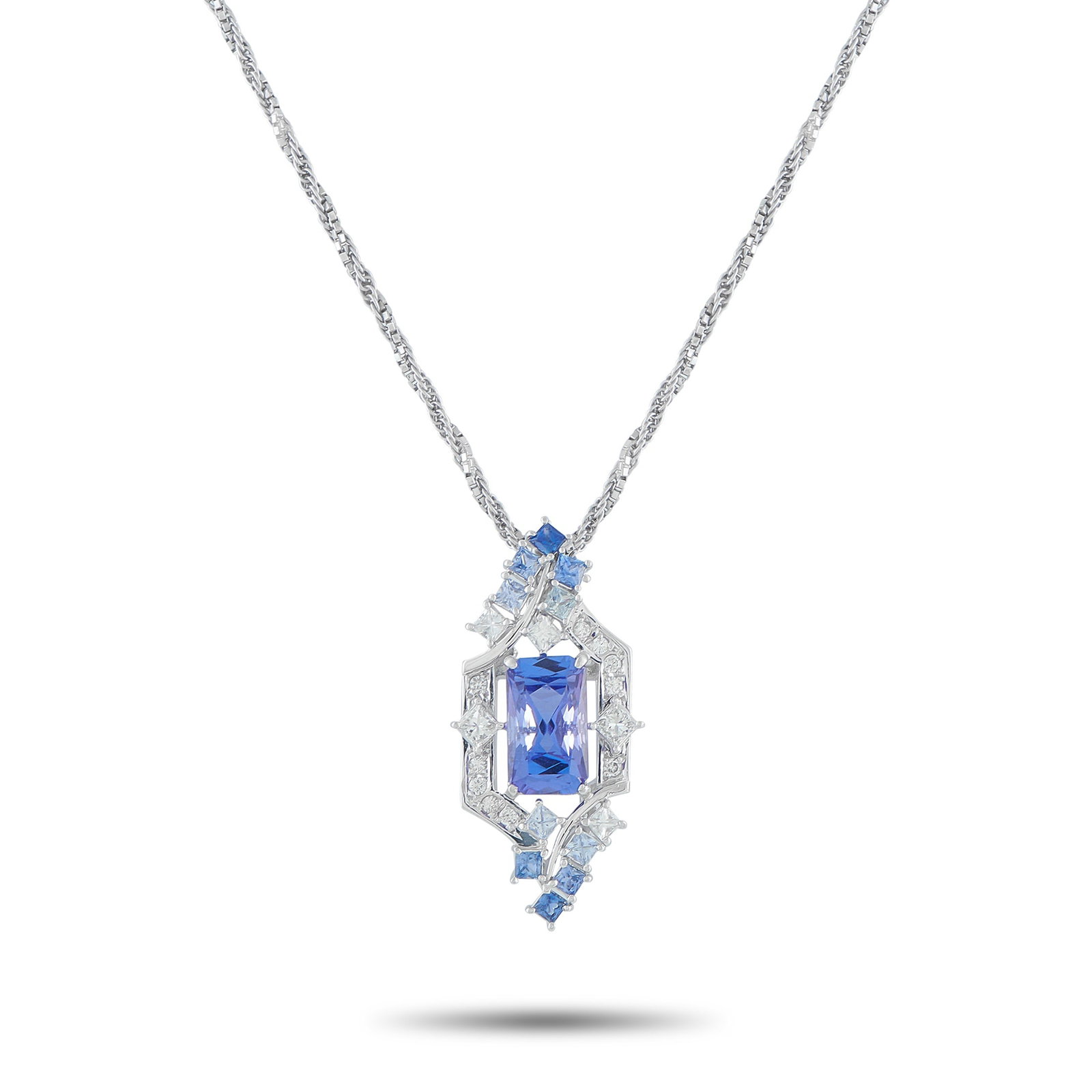 Platinum 0.48ct Diamond and Tanzanite Pendant: The design of this Exclusive necklace is a tapestry of form and texture. It starts with a meticulously twisted chain, where the structured precision of box links seamlessly meets the supple flow of a