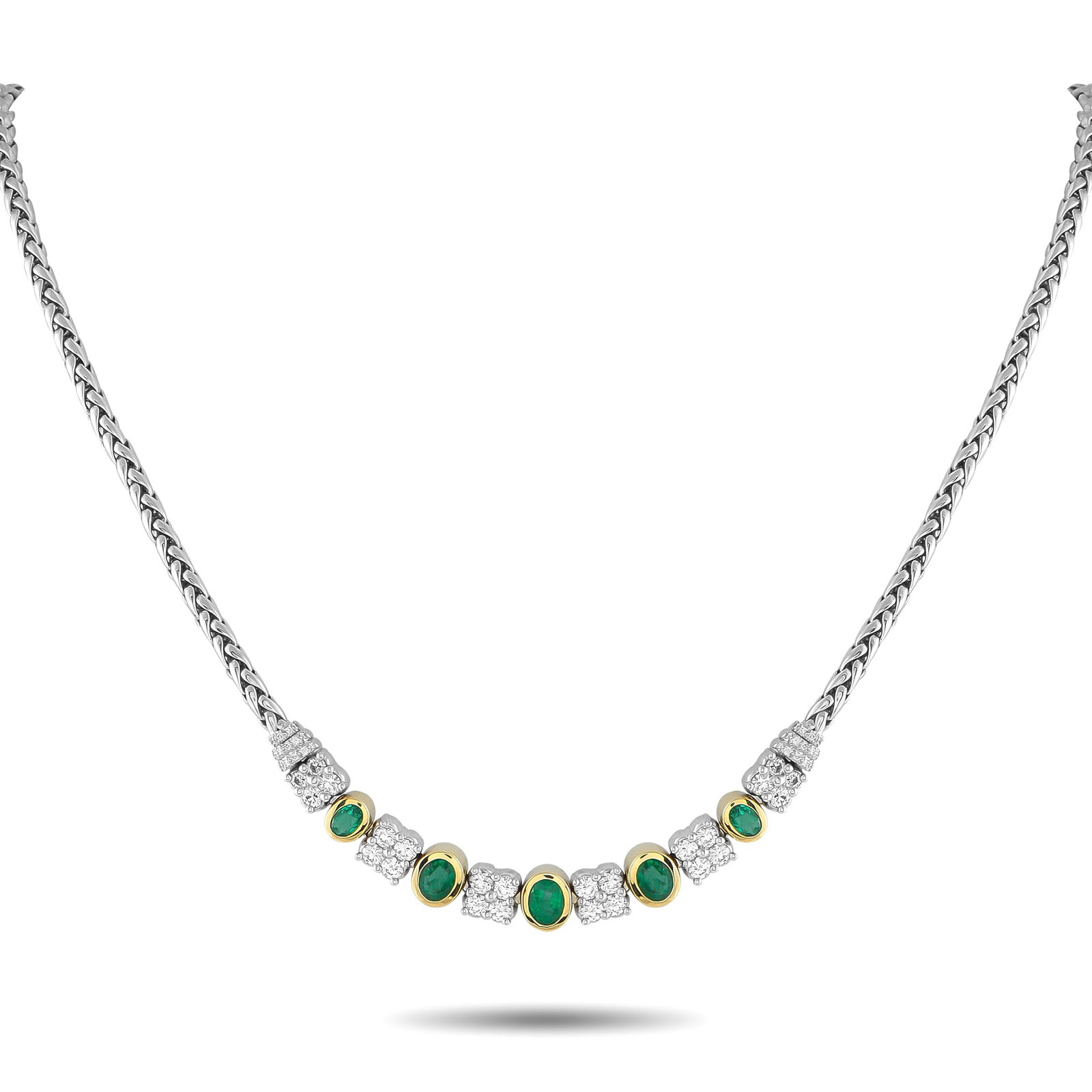 18K White and Yellow Gold 1.65ct Diamond and Emerald Necklace: An exquisite creation of style and presence. This Exclusive piece features a substantial woven chain, polished in the style of a wheat braid, that lends texture and strength. At its center are taperin