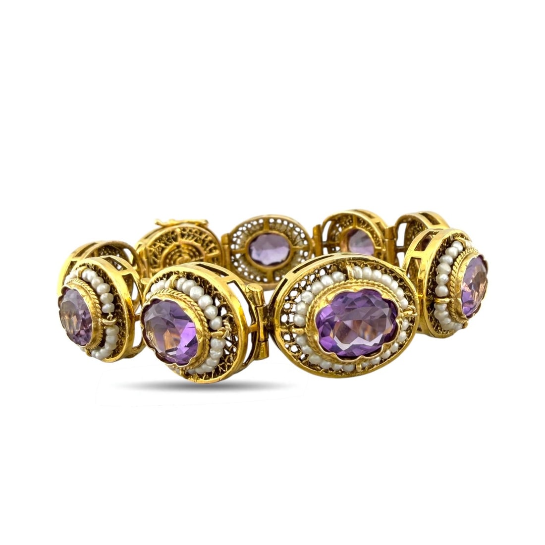 14K Yellow Gold Amethyst and Pearl Antique Link Bracelet: Exclusive 14K Yellow Gold Amethyst and Pearl Antique Link BraceletAn elegant antique bracelet composed of beautifully linked oval motifs, each centered with a richly colored amethyst. The gemstones ar