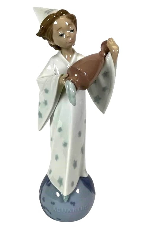 LLADRO AQUARIUS 1995-97 PORCELAIN FIGURINE 6216G: LLADRO AQUARIUS 1995-97 PORCELAIN FIGURINE 6216GLladro porcelain figurine titled 'Aquarius,' model number 6216, standing 10.5 inches tall. Features a figure in a star-patterned gown atop a blue spheri