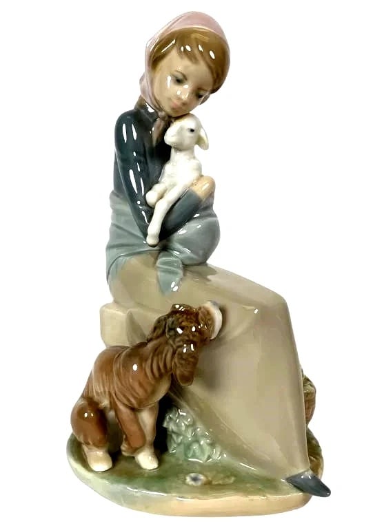 LLADRO DEVOTION 1974-90 PORCELAIN FIGURINE 1278G: LLADRO DEVOTION 1974-90 PORCELAIN FIGURINE 1278GGlossy porcelain figurine by Lladro titled Jealousy/Devotion, model number 1278, measuring 8.5 inches tall. Depicts a seated girl holding a lamb with a 