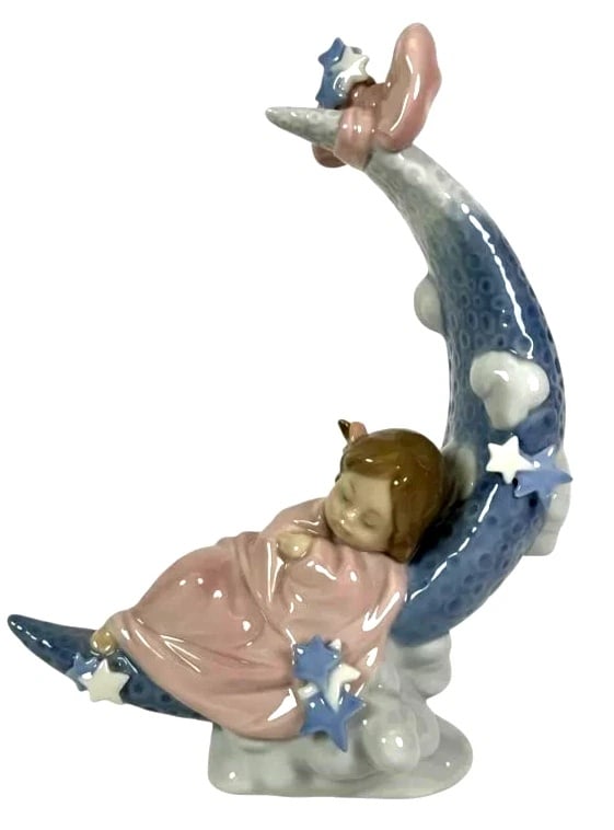 LLADRO HEAVEN'S LULLABY PORCELAIN FIGURINE 01006583: LLADRO HEAVEN'S LULLABY PORCELAIN FIGURINE 01006583Lladro porcelain figurine titled 'Heaven's Lullaby,' model number 6583. Depicts a child sleeping on a crescent moon adorned with stars, clouds, and a