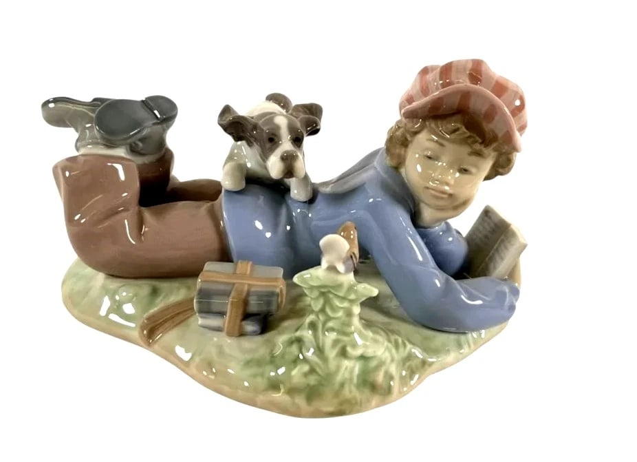 Lladro Limited Edition Porcelain Study Buddies 5451: Lladro Limited Edition Porcelain Study Buddies 5451Lladro porcelain figurine titled Study Buddies, model number 5451, featuring a boy reading a book with a dog on his back. Measures 7 inches in length