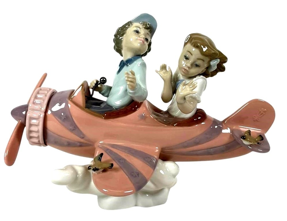 LLADRO RETIRED: 2004 DON'T LOOK DOWN LLADRO ITEM #01005698: LLADRO RETIRED: 2004 DON'T LOOK DOWN LLADRO ITEM #01005698Lladro porcelain figurine titled 'Don't Look Down #5698. Depicts two children in a vintage-style airplane with cloud base. Glossy pastel finis