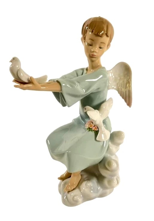 LLADRO SPRING ANGEL RETIRED: 1998: LLADRO SPRING ANGE LRETIRED: 1998Lladro porcelain figurine titled Spring Angel, model number 6146. Measuring 9 inches tall, the piece features an angel seated on a cloud, holding a dove, and surrounde