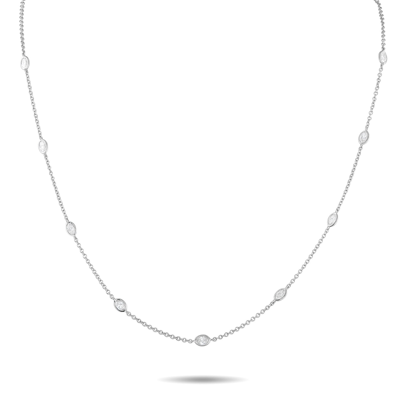 18K White Gold 1.50ct Diamond Station Necklace: This classically elegant necklace will never go out of style. Crafted from 18K White Gold, a series of oval-cut Diamonds with a total weight of 1.50 carats provide plenty of sparkle. It measures