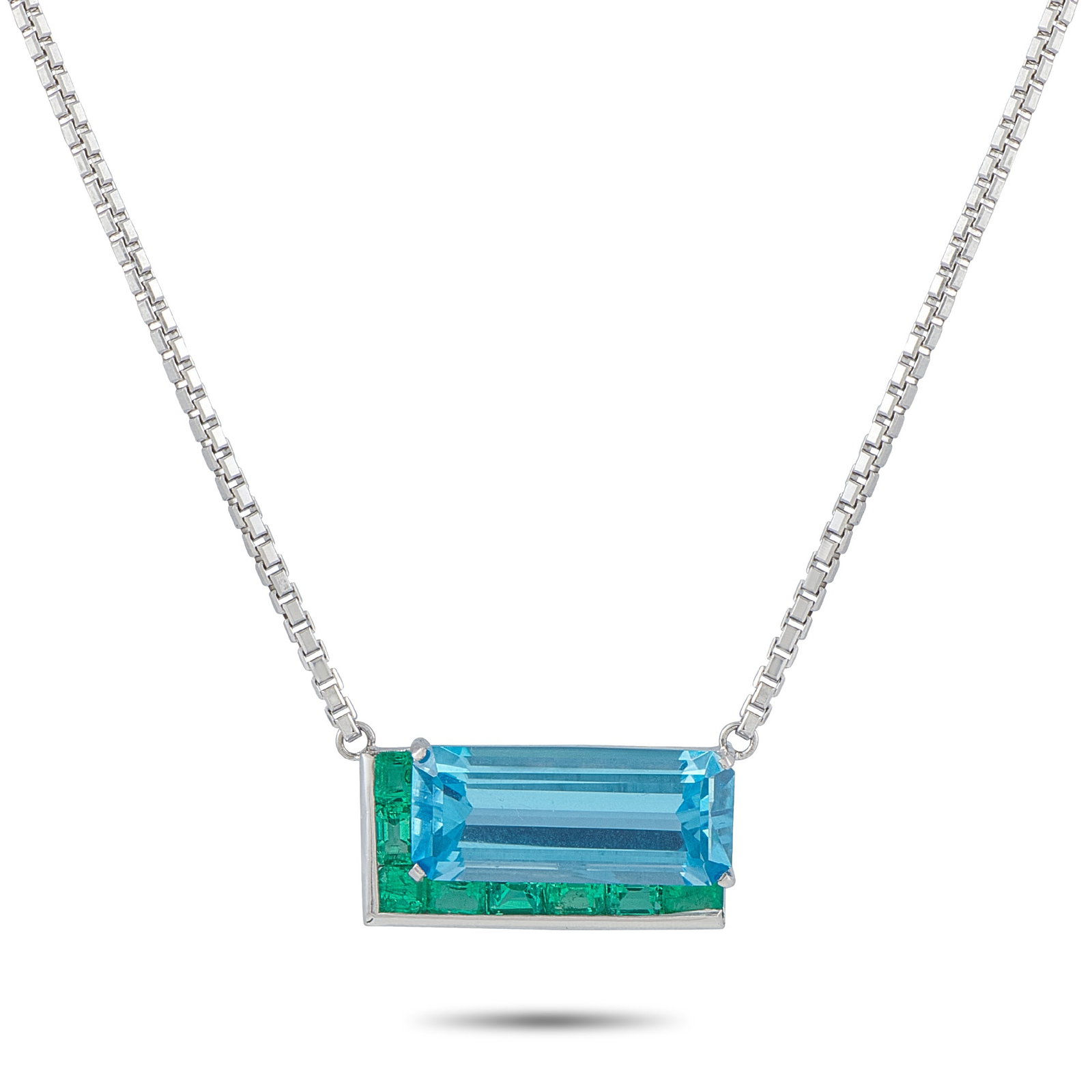 Platinum and 18K White Gold 1.20ct Emerald and Topaz Necklace: Bold colors come together in perfect harmony on this unforgettable necklace. Crafted from a combination of Platinum and 18K White Gold, this piece features a striking pendant at the center of a 20&rdq