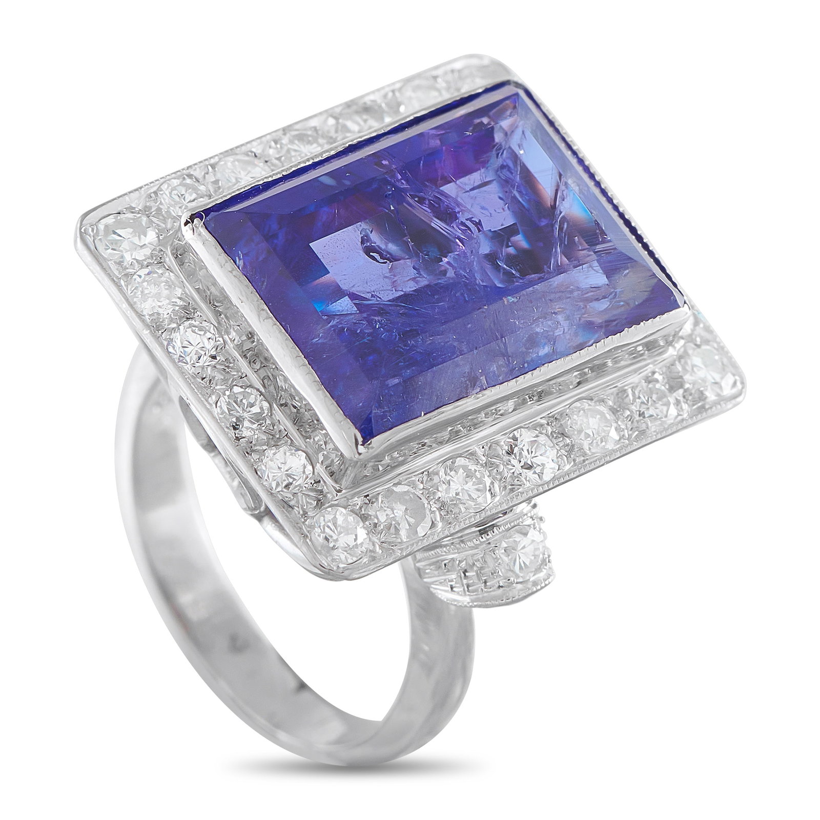 18K White Gold Diamond and Tanzanite Ring: A detailed 18K White Gold setting makes this ring elegant from any angle. Sparkling Diamonds surround this piece’s breathtaking 15.0 carat Tanzanite center stone, which provides this piece with a st