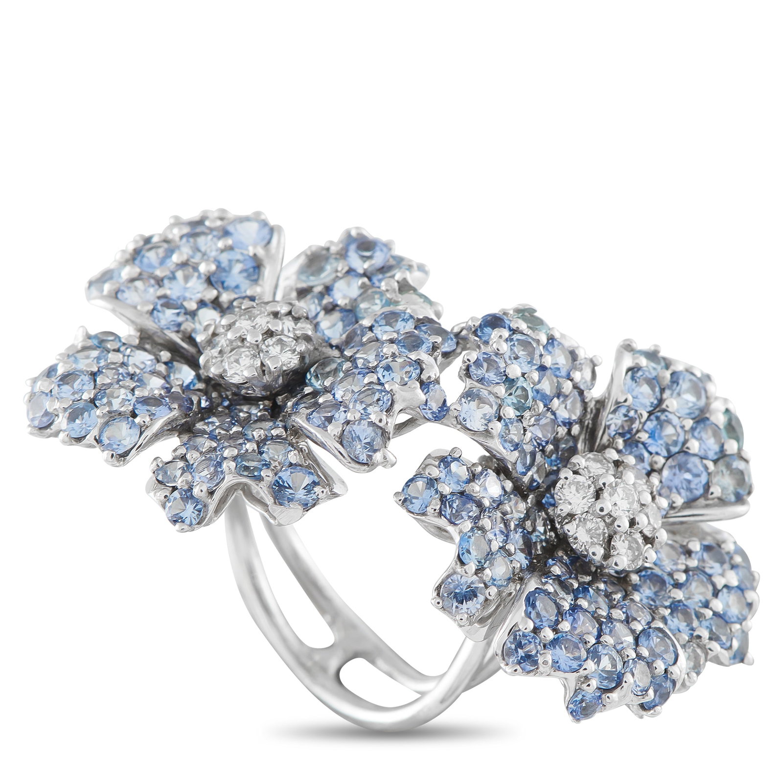 18K White Gold 0.50ct Diamond and Sapphire Flower Duo Statement Ring: A ring made to bridge and beguile. Designed as an oversized statement piece, this ring spans two fingers with an open profile and two bold centerpieces. On each end of the open shank is a floral cente