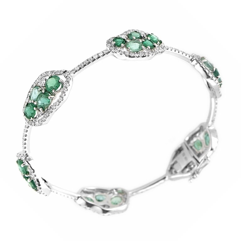 Single Row 18K White Gold Diamond and Emerald Bangle: This bangle is magnificent and sparkles with gemstones. The bracelet is made of 18K white gold and boasts a design comprised of ~6.18ct of emeralds and ~2.30ct of diamonds. Metal - 18K White Gold Diam