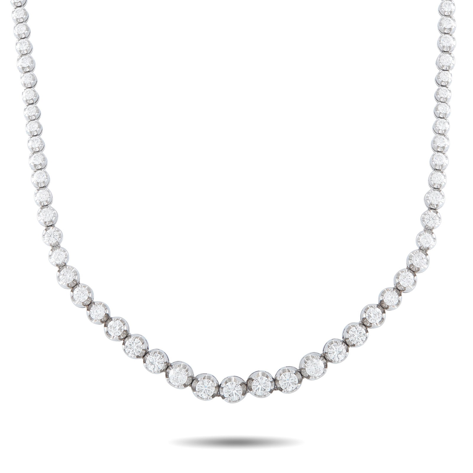 14K White Gold 7.0ct Diamond Tennis Necklace: Graduated Diamonds with a total weight of 7.0 carats make this classic tennis necklace shine brightly every time it catches the light. Set in 14K White Gold, this impressive piece measures 14” l