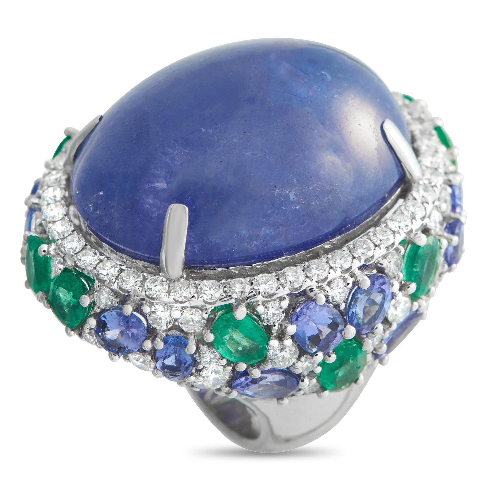 18K White Gold 3.61ct Diamond, Emerald, and Tanzanite Cocktail Ring: An Exclusive ring making an unapologetic statement that rewards close viewing as much as first glance. This white gold ring has a substantial 7mm band with a top height of 18mm. At the center is a mon