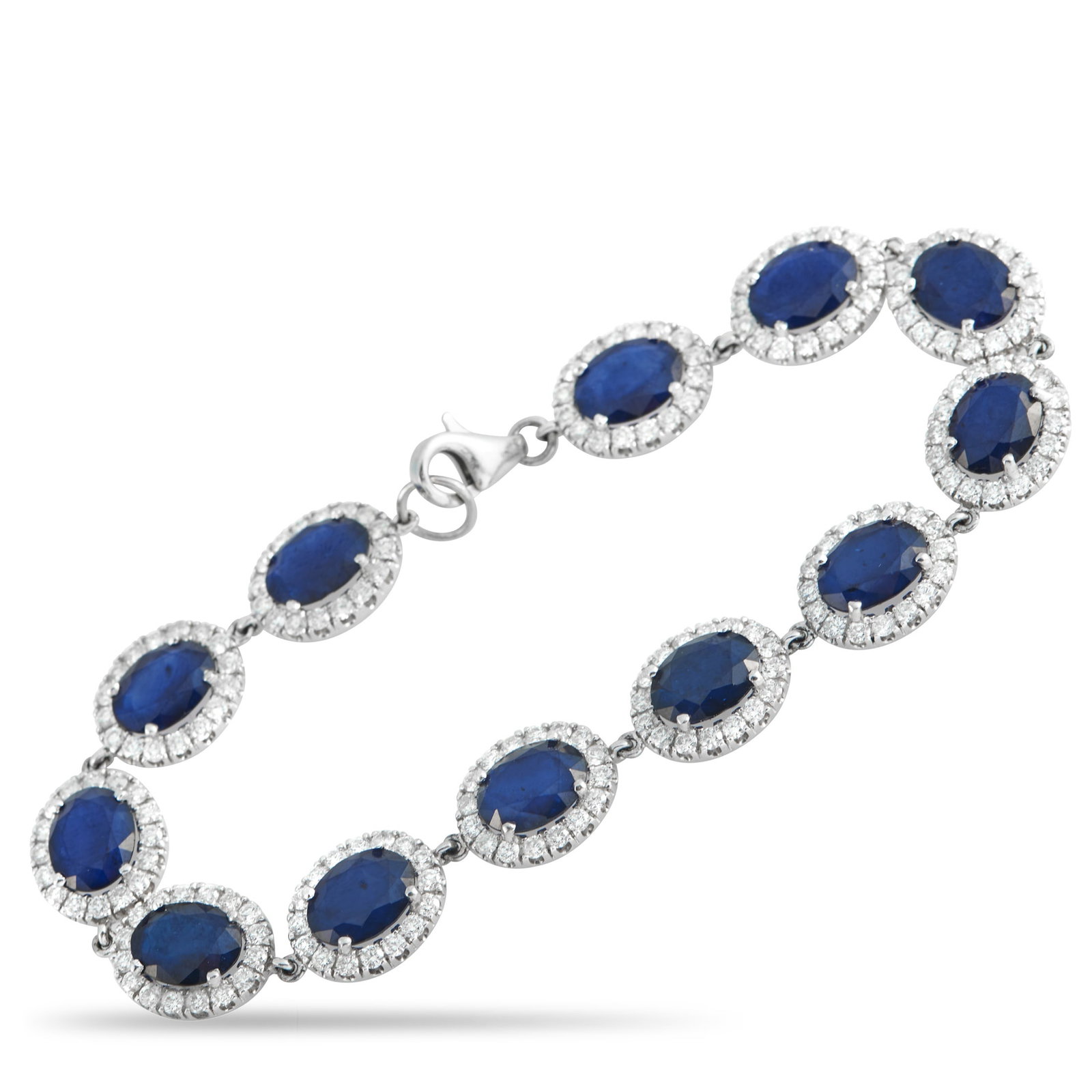 18K White Gold 4.92ct Diamond and Sapphire Bracelet: Regal in bearing, this Exclusive piece carries the poise of heirlooms once worn in court. The white gold bracelet is composed of oval sapphires totaling 24.23 carats. Each blue stone is held in four p