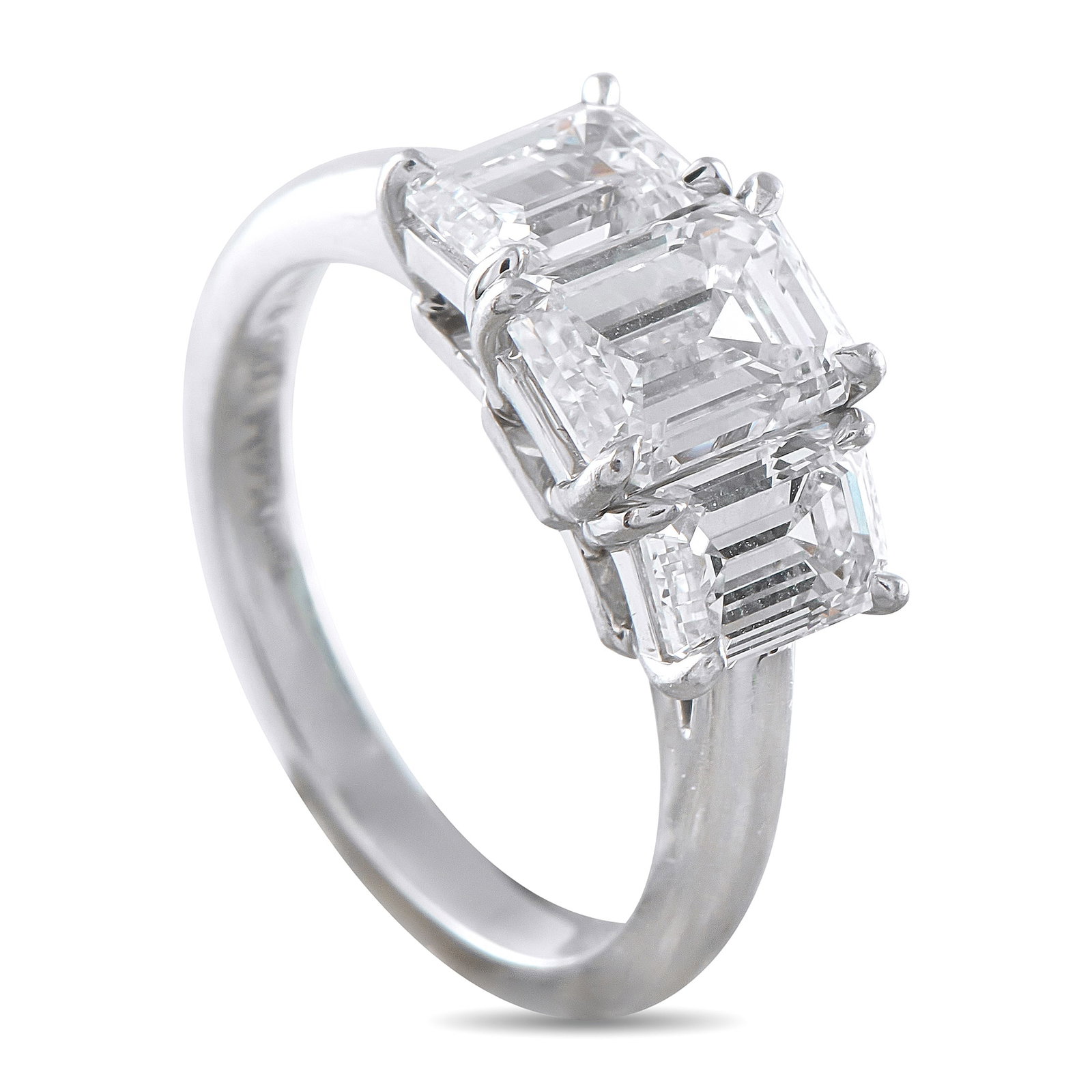 TIFFANY & CO. Tiffany & Co. Platinum 1.45ct Diamond Three-Stone Ring: This Tiffany & Co. three-stone ring offers a timeless sense of sophistication. Set in Platinum, an emerald-cut Diamond with H color and VVS2 clarity makes a statement at the center. A 0.74 carat Diamo