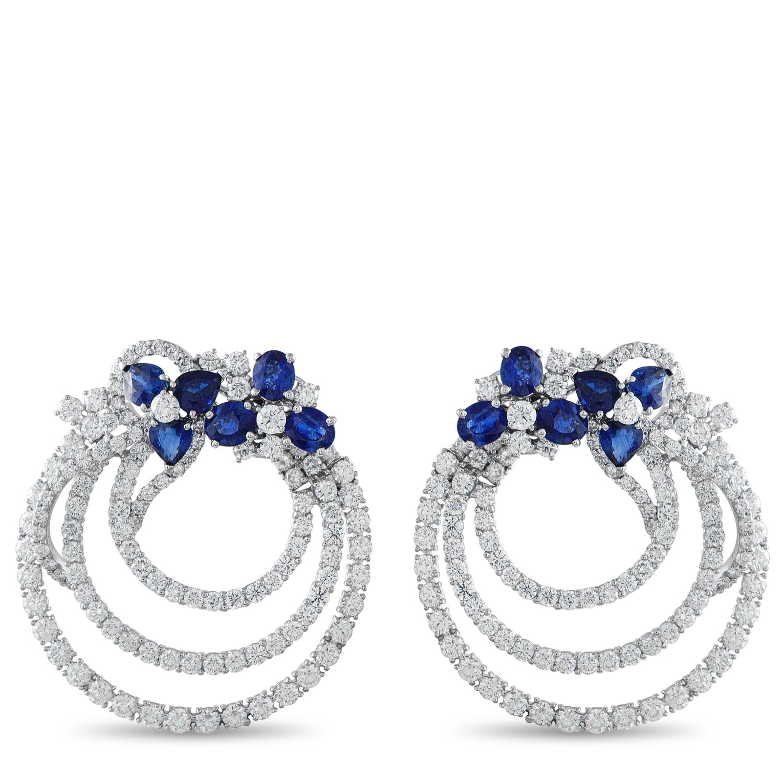 VALENTE MILANO 18K White Gold 13.82ct Diamond and Sapphire Clip-On Earrings: These Valente Milano earrings are poised to add a touch of luxury to any ensemble. Set in 18K White Gold, Diamonds with a total weight of 13.82 carats are perfectly paired with Sapphires totaling 9.25