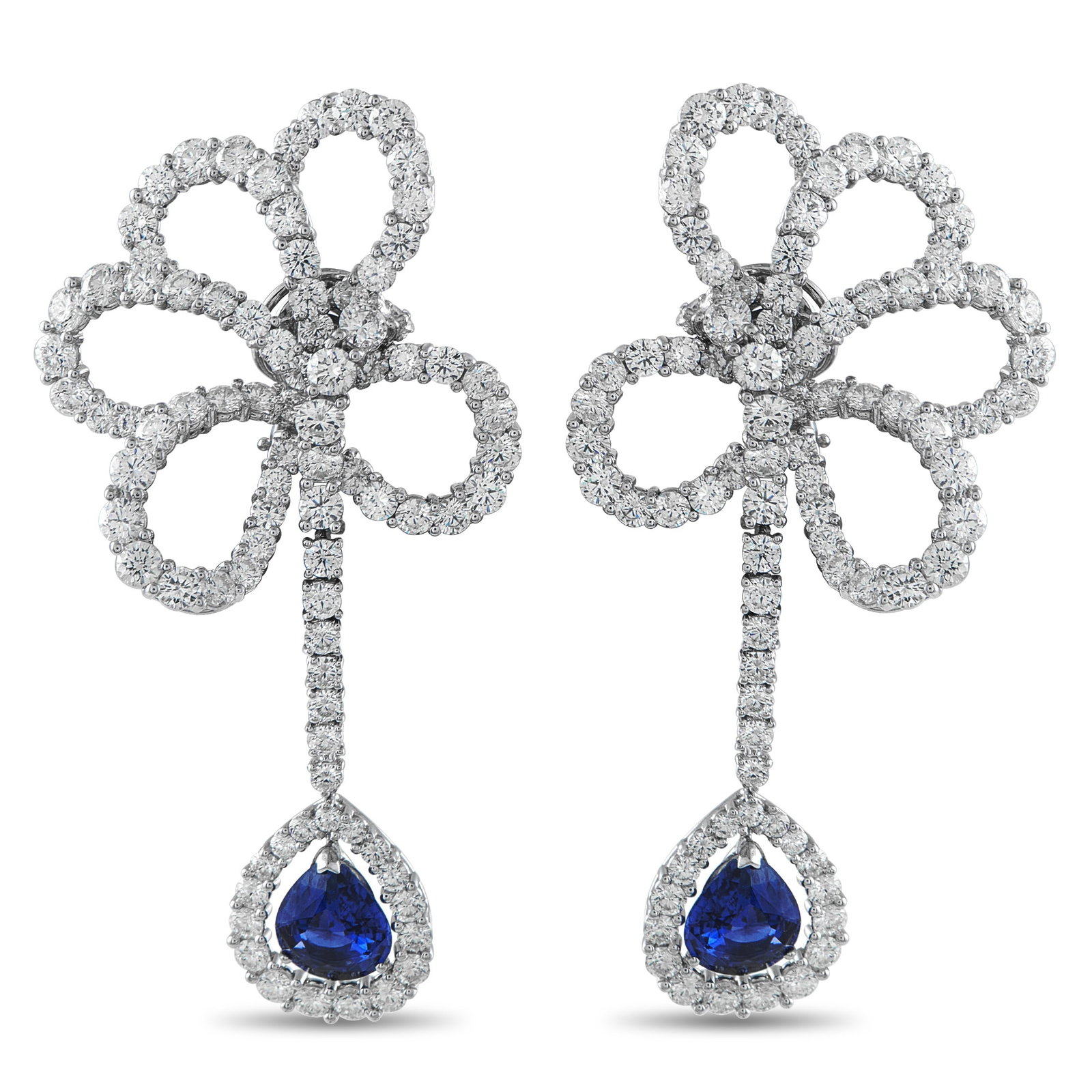 VALENTE MILANO 18K White Gold 17.10ct Diamond and Sapphire Clip-On Earrings: Delicate floral motifs make these Valente Milano earrings a dynamic addition to any ensemble. Diamonds with a total weight of 17.10 carats elevate the fluid 18K White Gold settings. Sapphires totaling