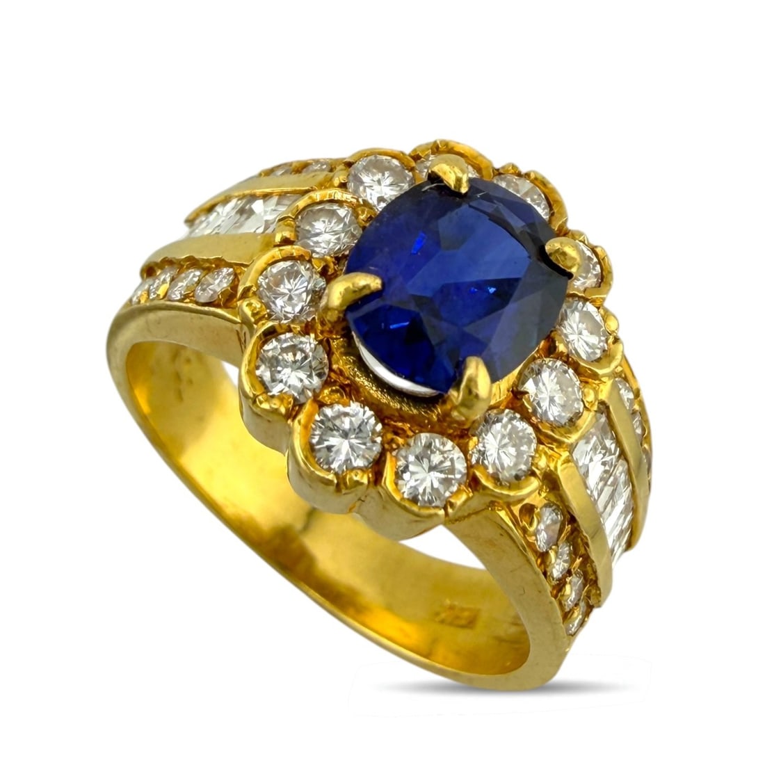 18K Yellow Gold 2.0ct Sapphire and 1.50ct Diamond Ring: 18K Yellow Gold 2.0ct Sapphire and 1.50ct Diamond Ring A refined yellow gold ring centered with an elegant oval cut sapphire, accented by delicate diamonds that add a subtle touch of brilliance. The c