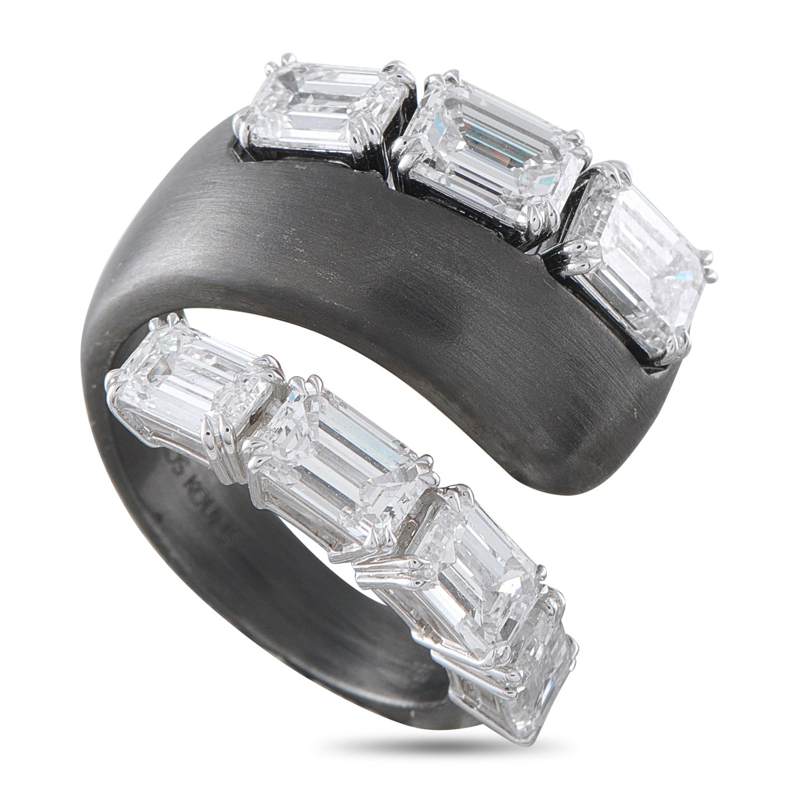 Nikos Koulis 18K White Gold and Titanium 5.14ct Diamond Ring: An asymmetrical wrapped design makes this Nikos Koulis ring instantly captivating. Bold and breathtaking, GIA-Certified emerald cut Diamonds with a total weight of 5.14 carats contrast against the min