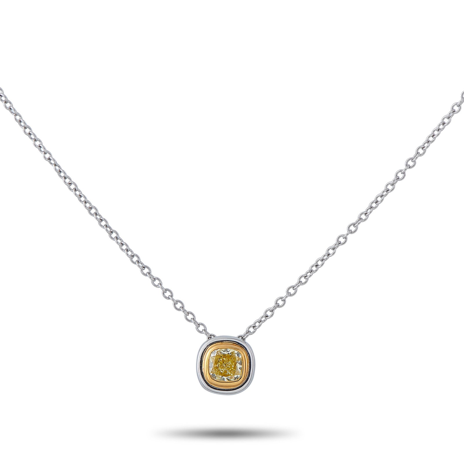 Tiffany & CO. Platinum 0.40ct Fancy Yellow Diamond Pendant: A simple, elegant design makes this Tiffany & Co. necklace an effortless choice. At the center of the Platinum pendant, a 0.40 carat Fancy Yellow Diamond adds a stylish pop of color. The pendant measu