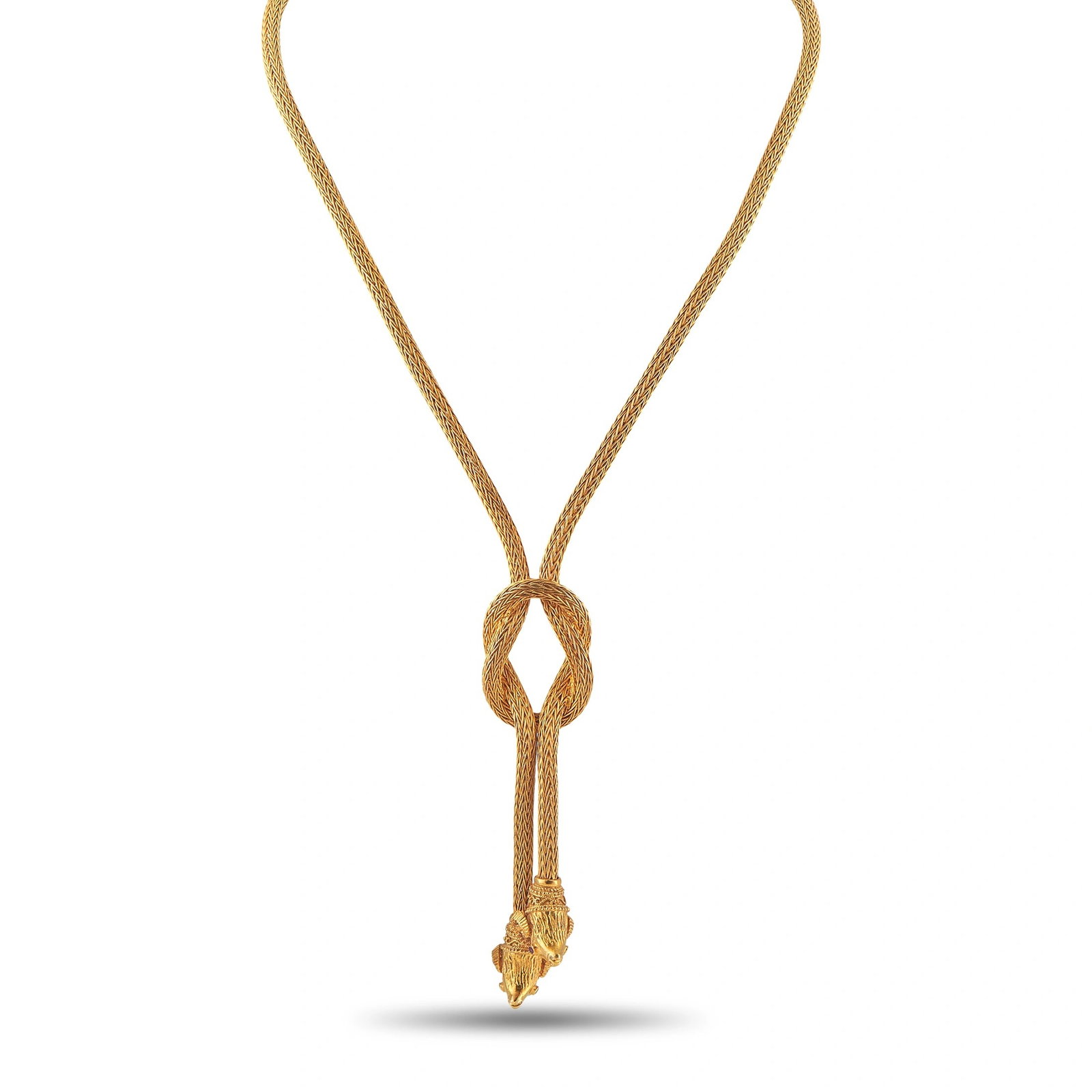 Ilias Lalaounis 18K Yellow Gold Ram Head Hercules Knot Lariat Necklace: A monumental lariat necklace in 18K yellow gold by Ilias Lalaounis, executed in the maison’s celebrated woven rope chain technique drawn from ancient Greek and archaeological traditions. The double-