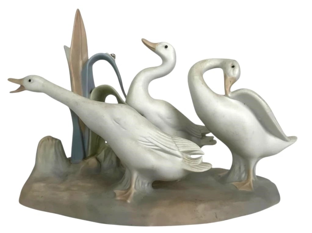 LLADRO GEESE GROUP 1969-96 PORCELAIN FIGURINE 4549G: LLADRO GEESE GROUP 1969-96 PORCELAIN FIGURINE 4549GLladro porcelain figurine titled 'Geese Group' (#4549), depicting three geese among reeds. Measuring 5.5 inches tall and 7.5 inches wide, the piece e