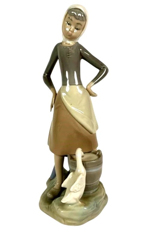 LLADRO GIRL WITH MILK PAIL 1970-91 PORCELAIN FIGURINE 4682G: LLADRO GIRL WITH MILK PAIL 1970-91 PORCELAIN FIGURINE 4682GPorcelain figurine titled 'Girl with Milk Pail and Goose,' numbered 4682 by Lladro. Features a girl standing beside a bucket and goose. Measu