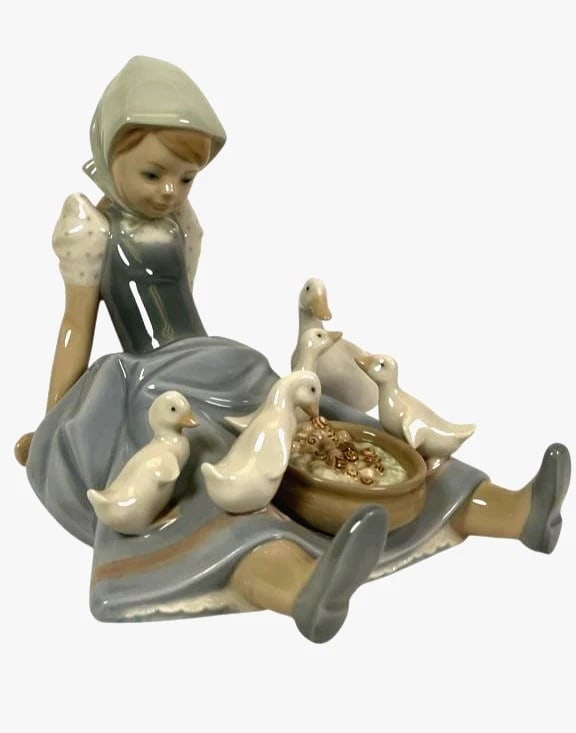 LLADRO MY HUNGRY BROOD 1980-97 PORCELAIN FIGURINE 5074G: LLADRO MY HUNGRY BROOD 1980-97 PORCELAIN FIGURINE 5074GLladro porcelain figurine titled My Hungry Brood (model #5074), depicting a young girl seated with a group of ducks surrounding a small bowl of f