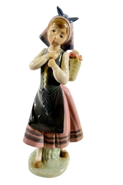 LLADRO NATURES BOUNTY 1982-97 PORCELAIN FIGURINE 1417G: LLADRO NATURES BOUNTY 1982-97 PORCELAIN FIGURINE 1417GRETIRED: 1995Lladro porcelain figurine titled Natures Bounty (#1417), designed with a young girl in traditional attire carrying a basket of detail