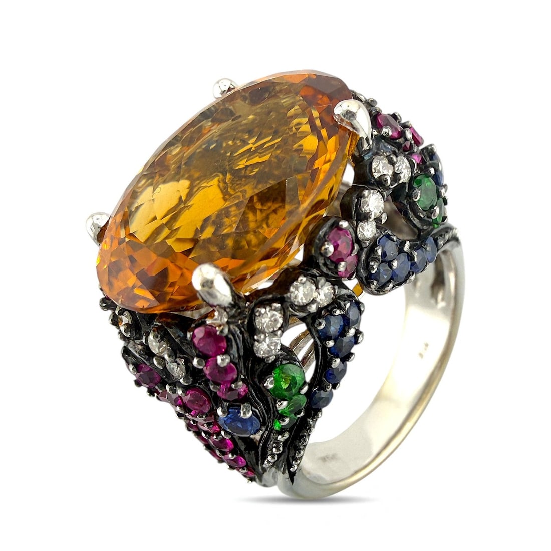 18K White Gold 10ct Citrine and Multigem Cocktail Ring: 18K White Gold 10.0ct Citrine and Multigem Cocktail Ring This bold cocktail ring is crafted in 18K white gold and features a large oval-cut citrine at its center, surrounded by a vibrant arrangement o