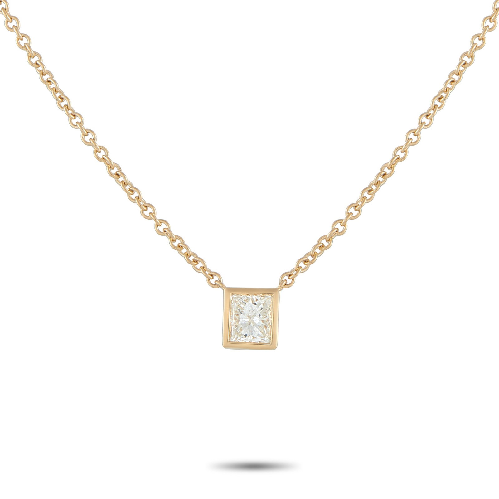 18K Yellow Gold 0.60ct Princess-Cut Diamond Solitaire Necklace: A simple and refined piece perfect for daily wear. A sharp, square princess-cut diamond takes center stage, its facets catching light with crisp, geometric brilliance. It is held securely by a smooth 