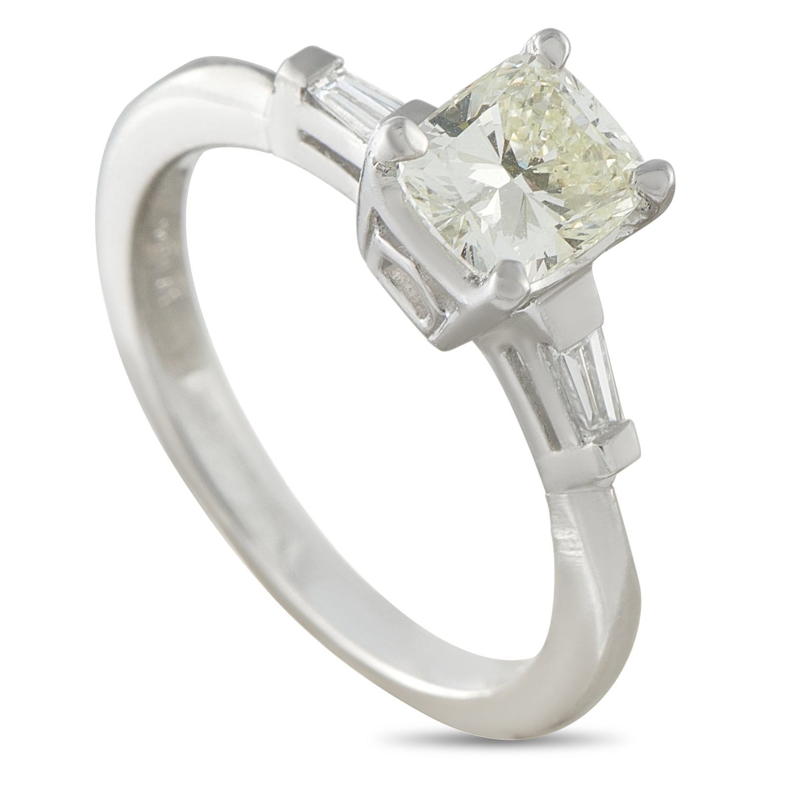 Platinum 1.12ct Diamond Ring: At first glance, this ring appears like a classic solitaire. It carries a 1-carat center diamond raised prominently in a four-prong setting above a clean 2mm platinum band. The elevated 7mm top height