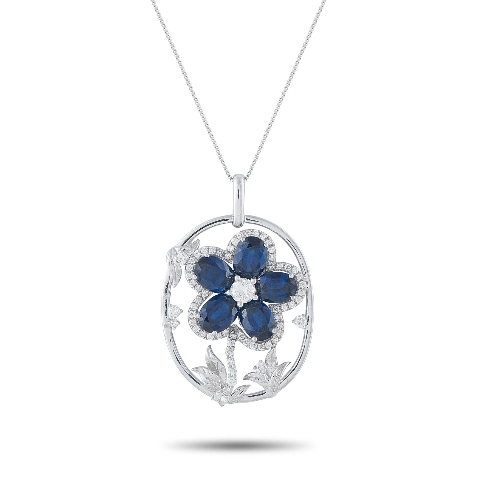 Platinum 1.26ct Diamond and Sapphire Flower Pendant: A breathtaking flower pendant in platinum, featuring six oval blue sapphires totaling 9.57 ct arranged as petals around a round diamond center, framed by a diamond halo and engraved floral motifs with