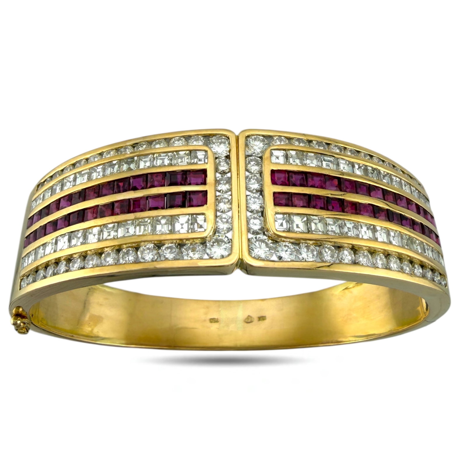 18K Yellow Gold 5.2ct Ruby and 7.02ct Diamond Hinged Bracelet: 18K Yellow Gold 5.2ct Ruby and 7.02ct Diamond Hinged Bracelet This stunning bracelet features a sophisticated and symmetrical design set in 18K yellow gold. The hinged band opens to reveal two matchin