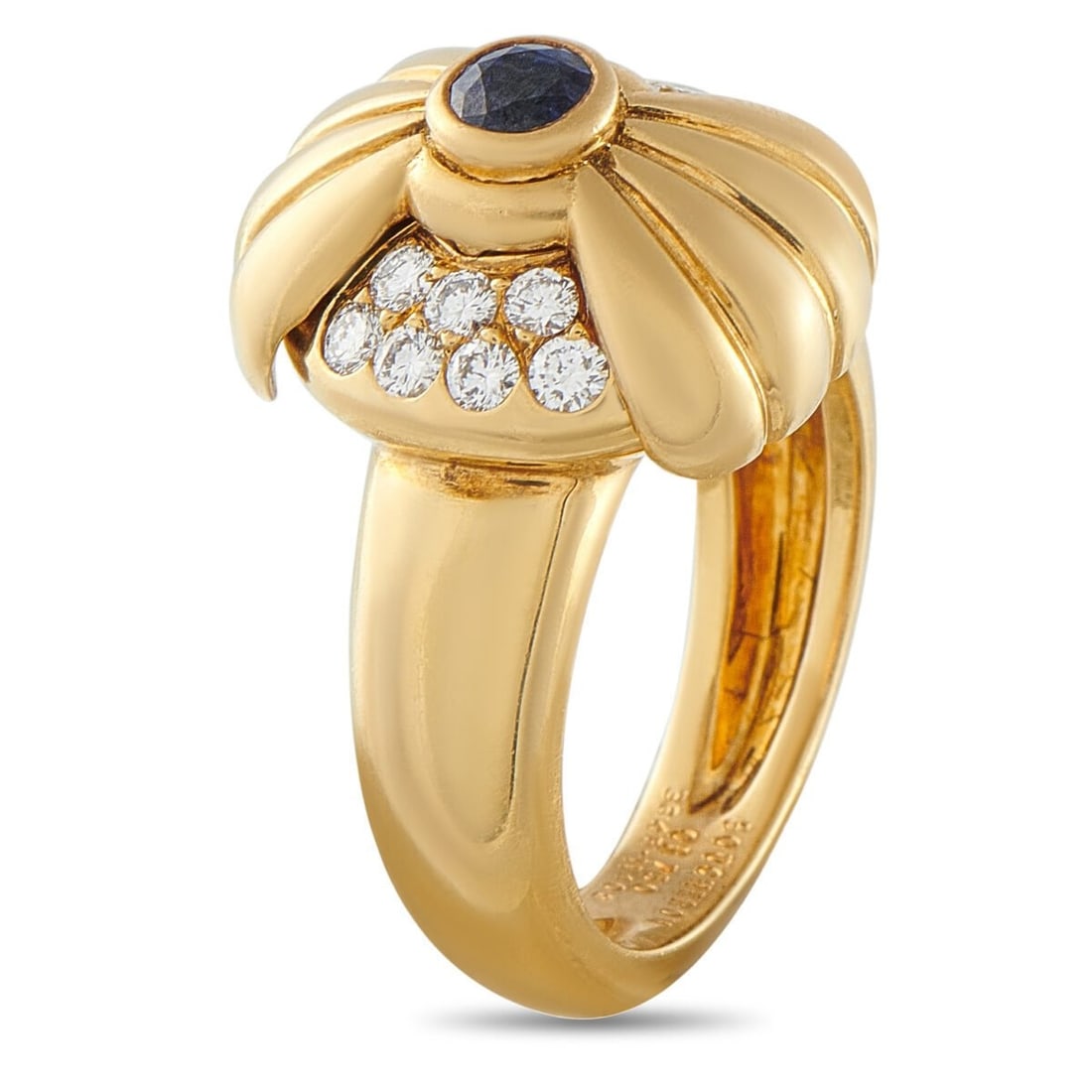 Boucheron 18K Yellow Gold 0.4ct Diamond and Sapphire Ring Circa 1970: Simple and stylish, this Boucheron ring is a classic piece that will never go out of style. Inset Diamonds with a total weight of 0.4 carats make a statement on each side of the design and highlight t