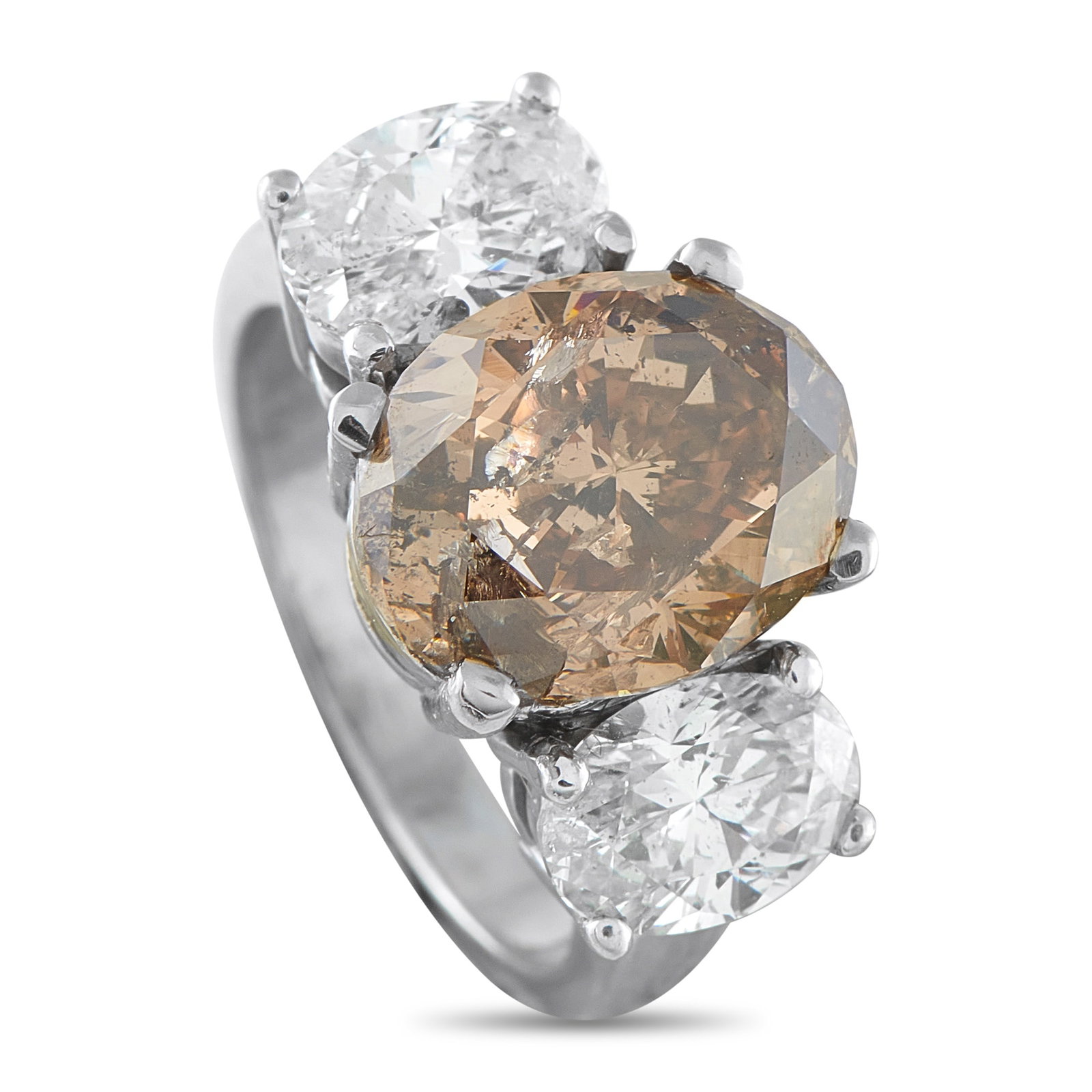 18K White Gold 6.70ct Diamond Ring: Despite the traditional three-stone design, this luxury ring is anything but ordinary. At the center, a 4.90 carat Cognac Diamond adds a touch of warmth and sophistication to the overall design.
