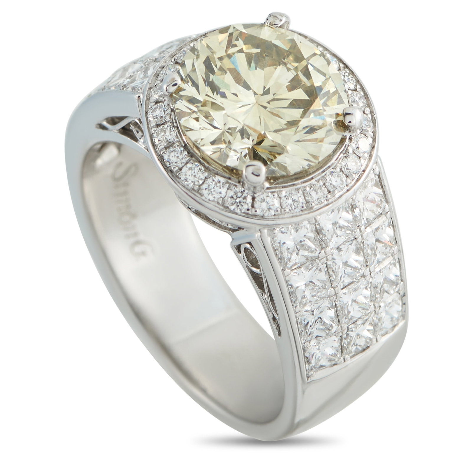 18K White Gold 4.61ct Diamond Ring: This ring will add touch of luxury to any occasion. At the center of the intricate 18K White Gold setting, a warm-hued 2.77 carat Diamond adds subtle color to the overall design. Sparkling Diamond