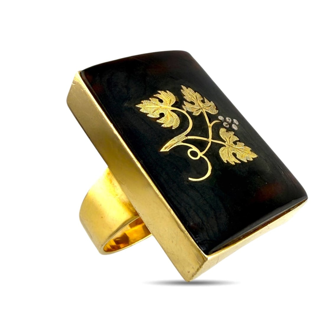 Vintage 14K Yellow Gold Floral Rectangular Ring: Vintage 14K Yellow Gold Floral Rectangular Ring This distinctive vintage ring is crafted in 14K yellow gold and features a bold rectangular face with an elegant raised floral gold design. The warm yel