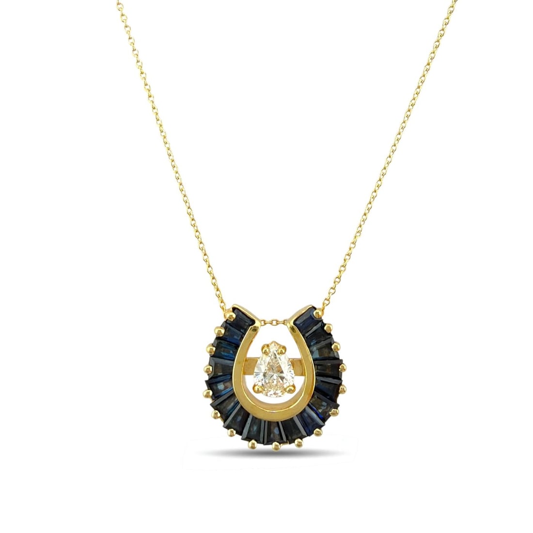 14K Yellow Gold Sapphire and 0.3ct Diamond Shoehorn Pendant Necklace: 14K Yellow Gold Sapphire and 0.3ct Diamond Shoehorn Pendant Necklace A distinctive and elegant necklace centered by a refined shoehorn design pendant, accented with richly colored sapphires and a susp