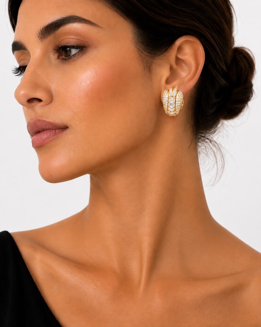 Bvlgari Vintage 18K Yellow Gold 12.0ct Diamond Earrings: These vintage Bvlgari earrings are crafted in 18K yellow gold in a tapered, domed shield design, pave-set with round brilliant and baguette-cut diamonds totaling approximately 12.0 carats. The earring