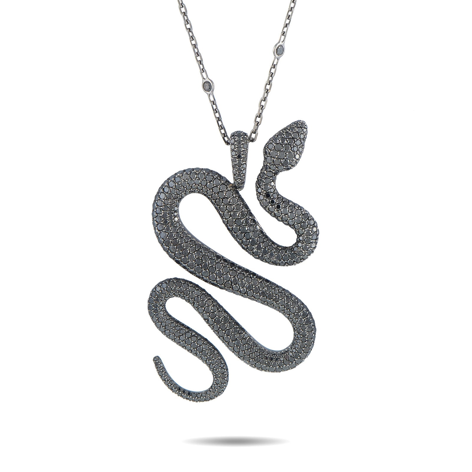 Messika 18K White Gold Black Diamond Snake Pendant: A bold, dramatic design makes this Messika necklace incredibly eye-catching. Crafted from 18K White Gold, the stunning snake pendant is elevated by a dazzling array of Black Diamonds. The pendant meas