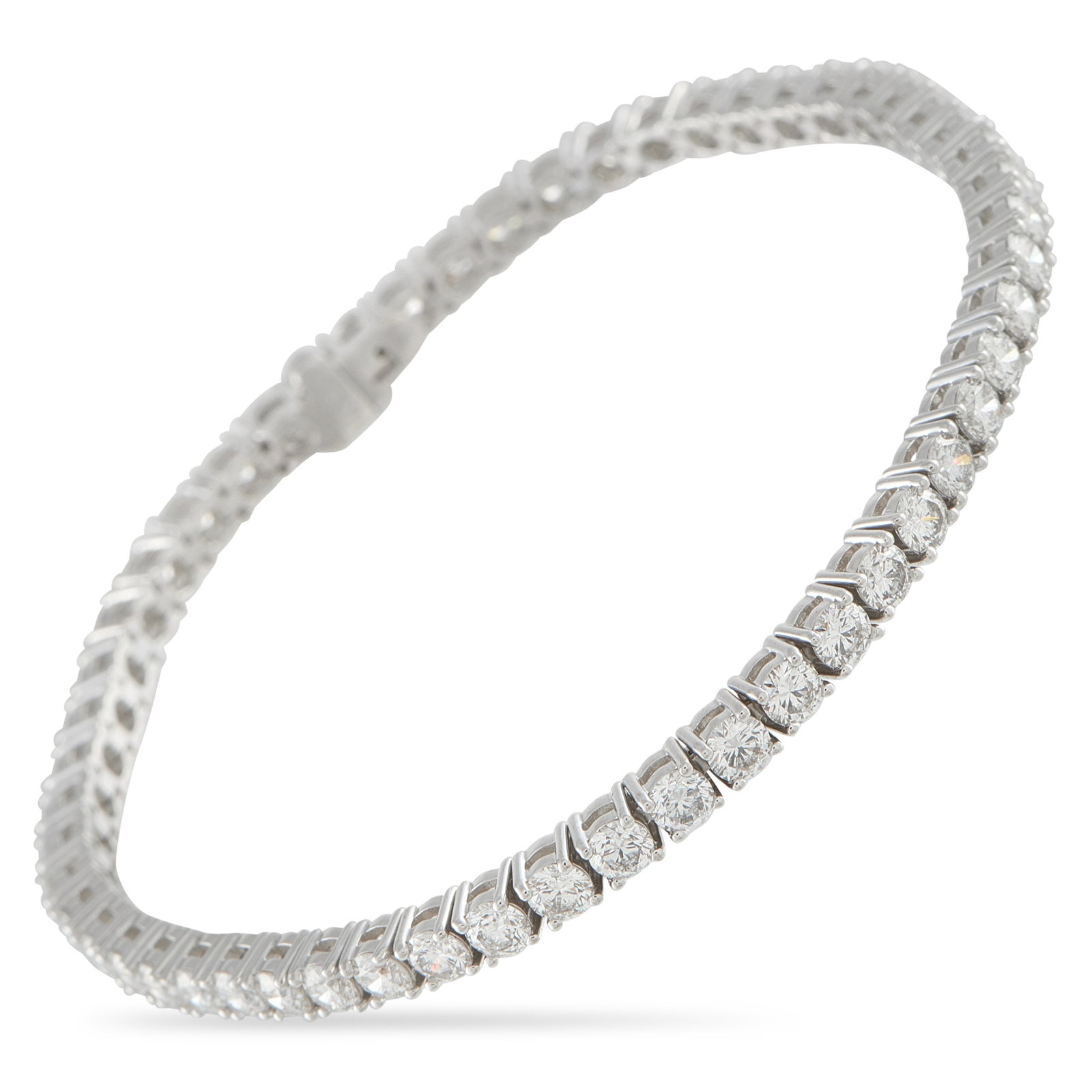 18K White Gold 6.91ct Diamond Tennis Bracelet: A classically elegant design makes this tennis bracelet an essential addition to any jewelry collection. Set in 18K White Gold, Diamonds with a total weight of 6.91 carats provide endless sparkle. It