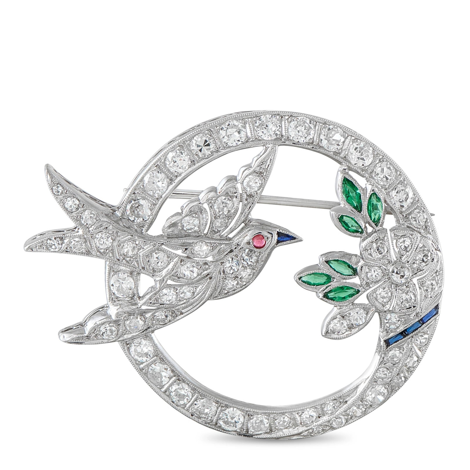 Antique 18K White Gold 2.70ct Diamond and Emerald Bird Brooch: Natural design elements give this antique brooch a timeless sense of sophistication. The detailed 18K White Gold setting beautifully displays a floral motif and a bird in flight. Diamonds with a total