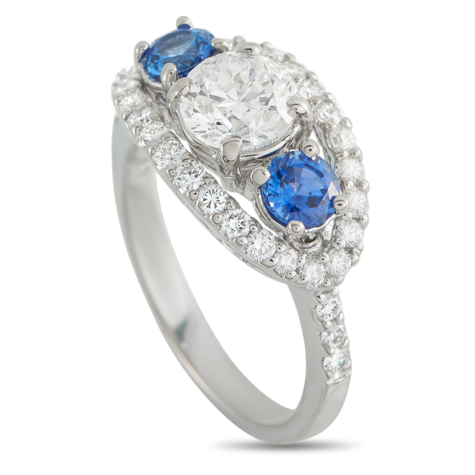 14K White Gold 1.71ct Diamond and Sapphire Ring: Pairing brilliance with deep color, this ring showcases the enduring harmony between diamond and sapphire. At the center sits a 1.01-carat round diamond, flanked by round sapphires on either side,