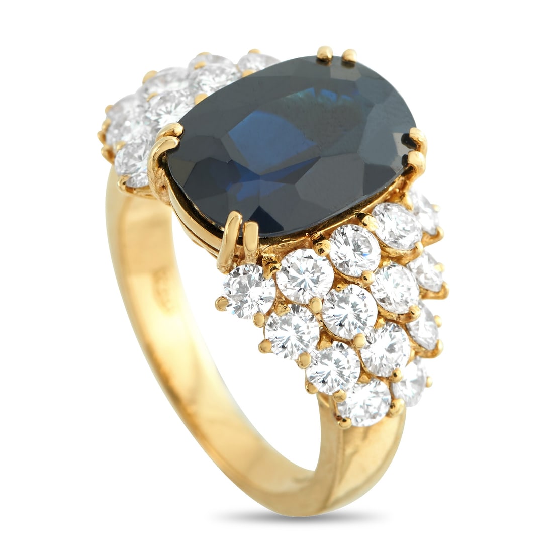 18K Yellow Gold 1.68ct Diamond and Sapphire Ring: Radiating regal poise, this ring cradles a 5.25-carat oval sapphire held by paired prongs on four corners for a more deliberate profile. Flanking the center, clusters of round diamonds totaling 1.68 c