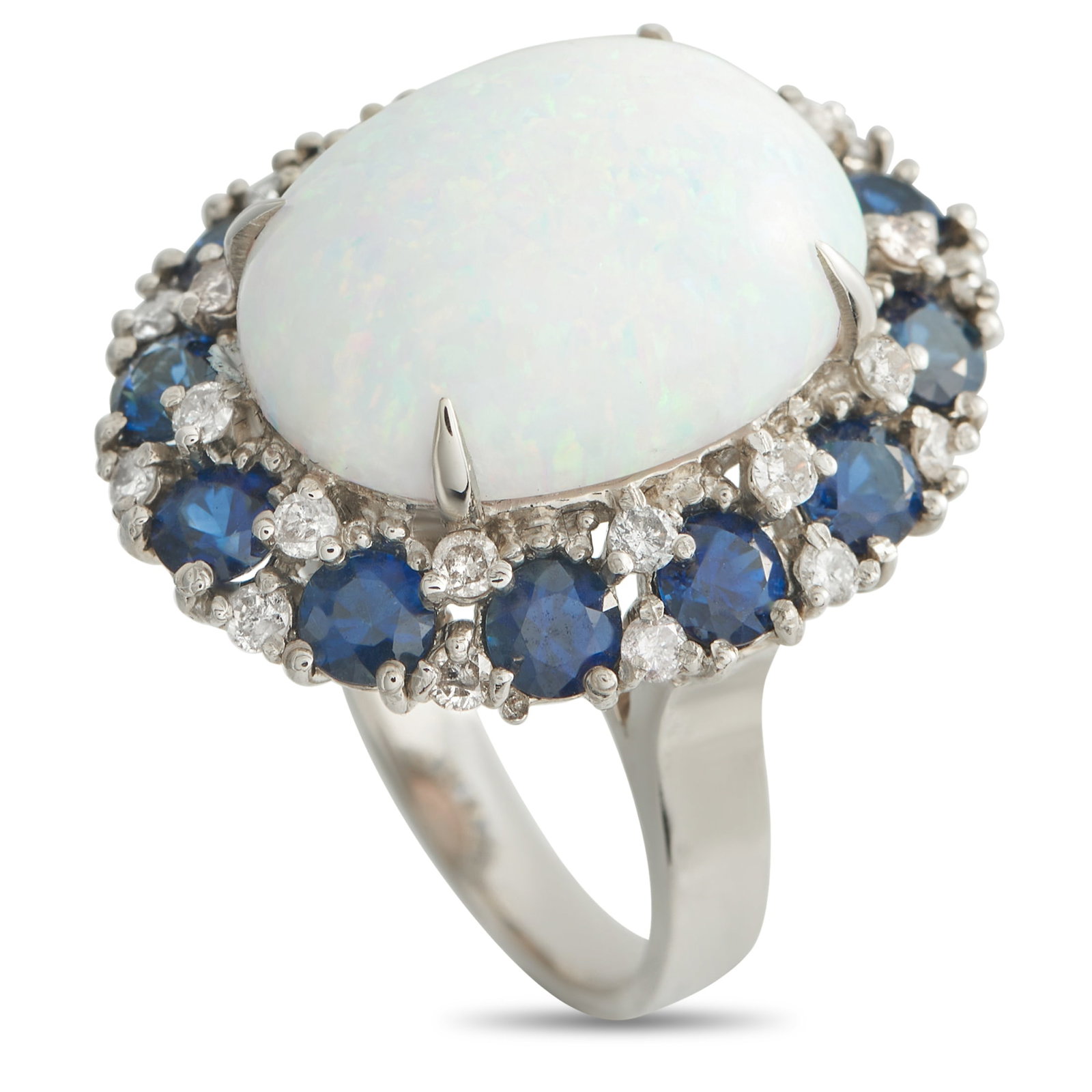 14K White Gold 0.45ct Diamond, Sapphire, and Opal Ring: A striking combination of colors and materials makes this ring simply unforgettable. At the center, a glistening 5.0 carat Opal instantly captures the imagination. It’s surrounded by a halo of spark