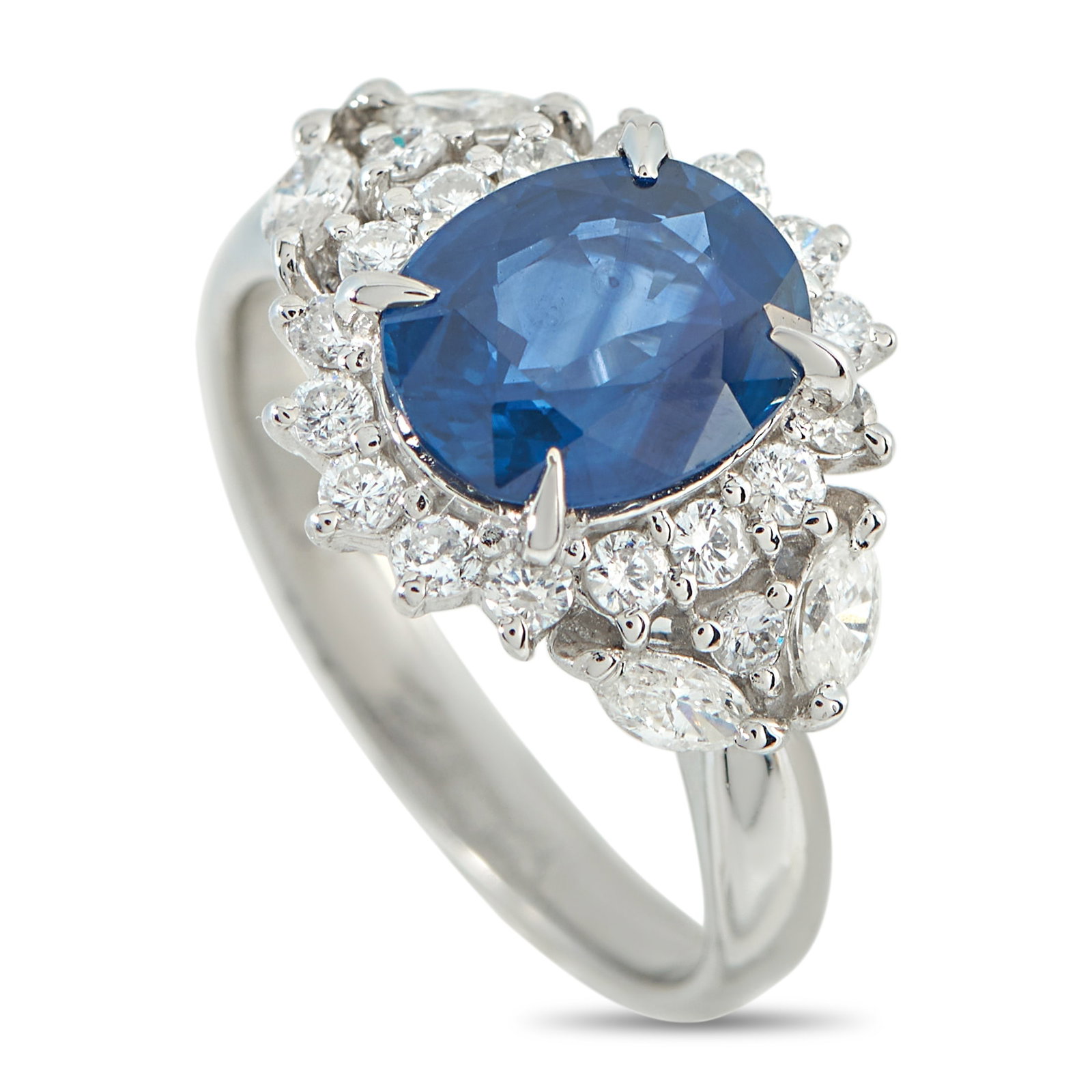Platinum 0.70ct Diamond and Sapphire Ring: Designed with classic allure and perennial charm. At the center of this platinum ring is a rich oval sapphire held by four claw prongs. Surrounding it, a halo of sunburst-set diamonds delivers a