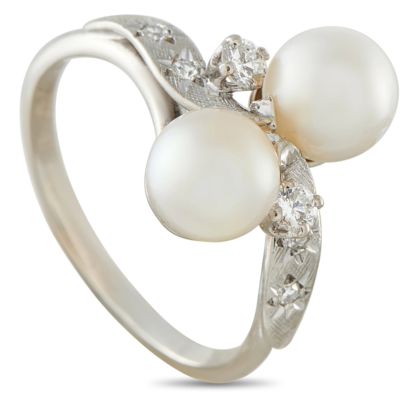 Vintage 18K White Gold 0.16ct Diamond and Pearl Bypass Ring: A graceful vintage French bypass ring in 18K white gold, featuring two 7mm cultured pearls sweeping past one another along an engraved shank set with single-cut diamonds totaling 0.16 carats. Weighing